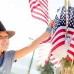 4th of July in Spokane, WA - Photo of child picking out a flag