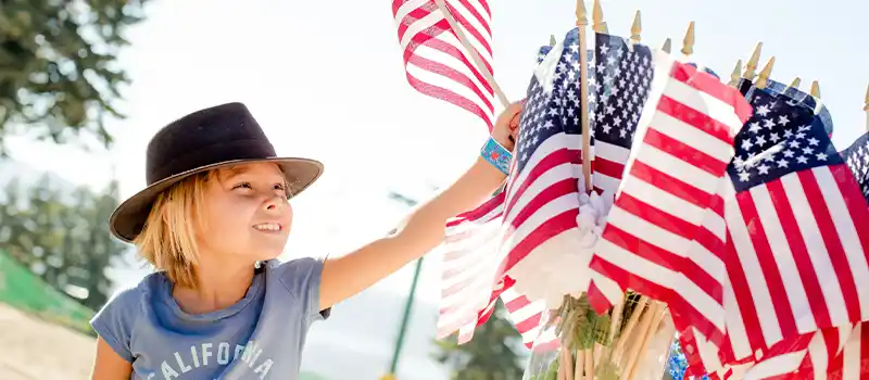 4th of July in Spokane, WA - Photo of child picking out a flag