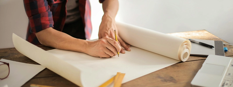 Contractors Insurance in Washington - Image of a person outlining plans on a piece of paper